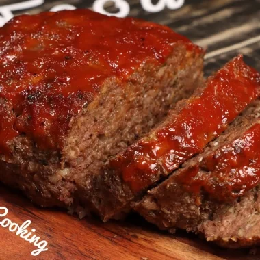 Homemade Southern soul food meatloaf with a tangy tomato glaze, sliced and ready to serve.