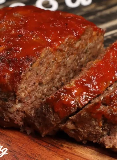 Homemade Southern soul food meatloaf with a tangy tomato glaze, sliced and ready to serve.