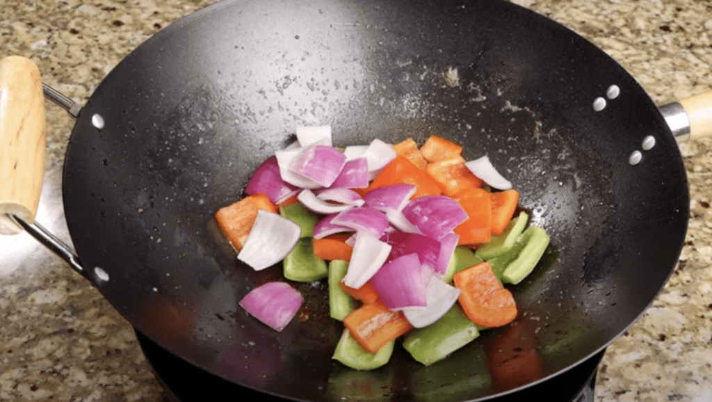 Saute bell pepper and onion  for Sweet and Sour Chicken