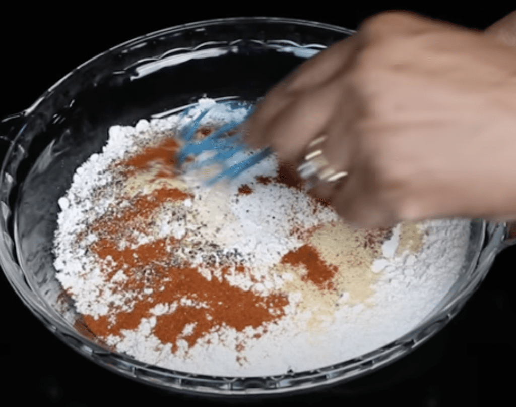 seasoning the batter for chicken and waffles