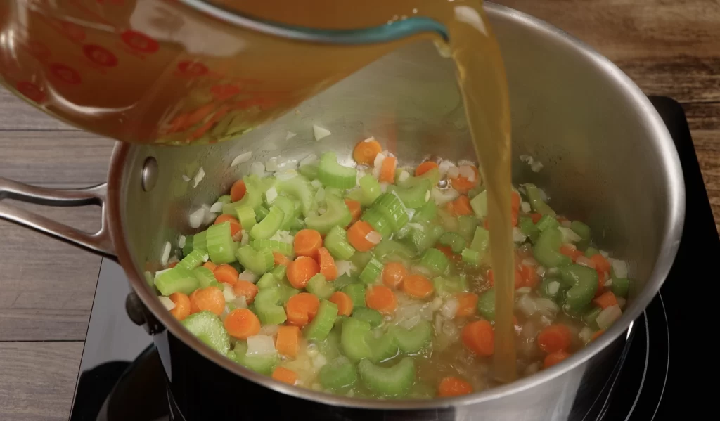 adding the turkey stock for the turkey gravy