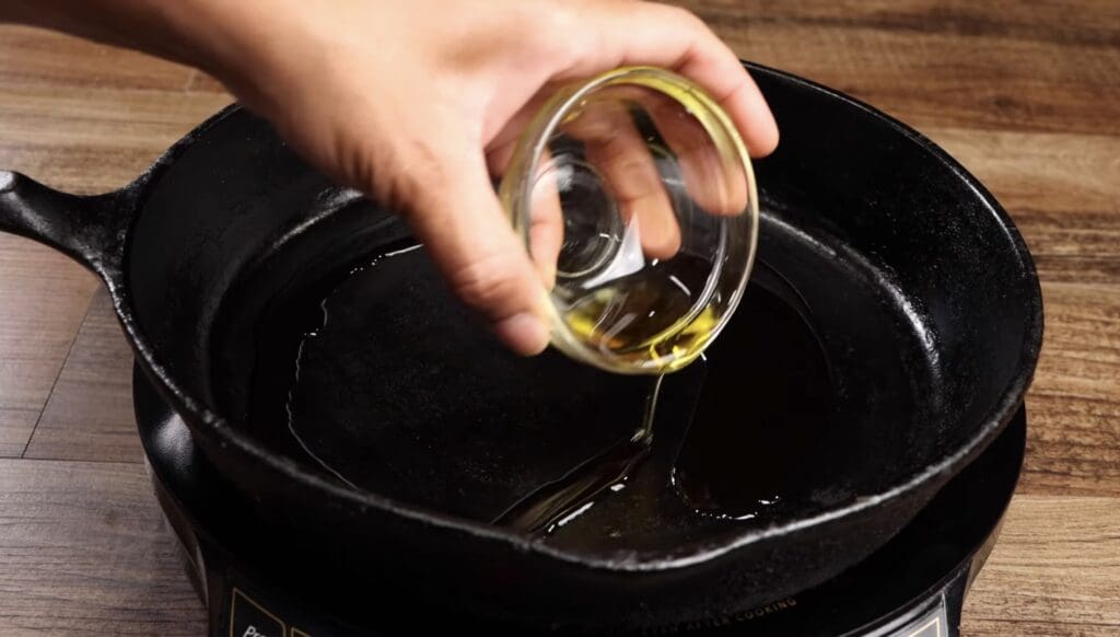 adding the olive oil to the skillet