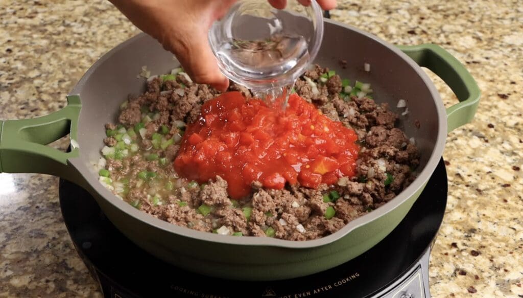 adding the diced tomatoes and water 