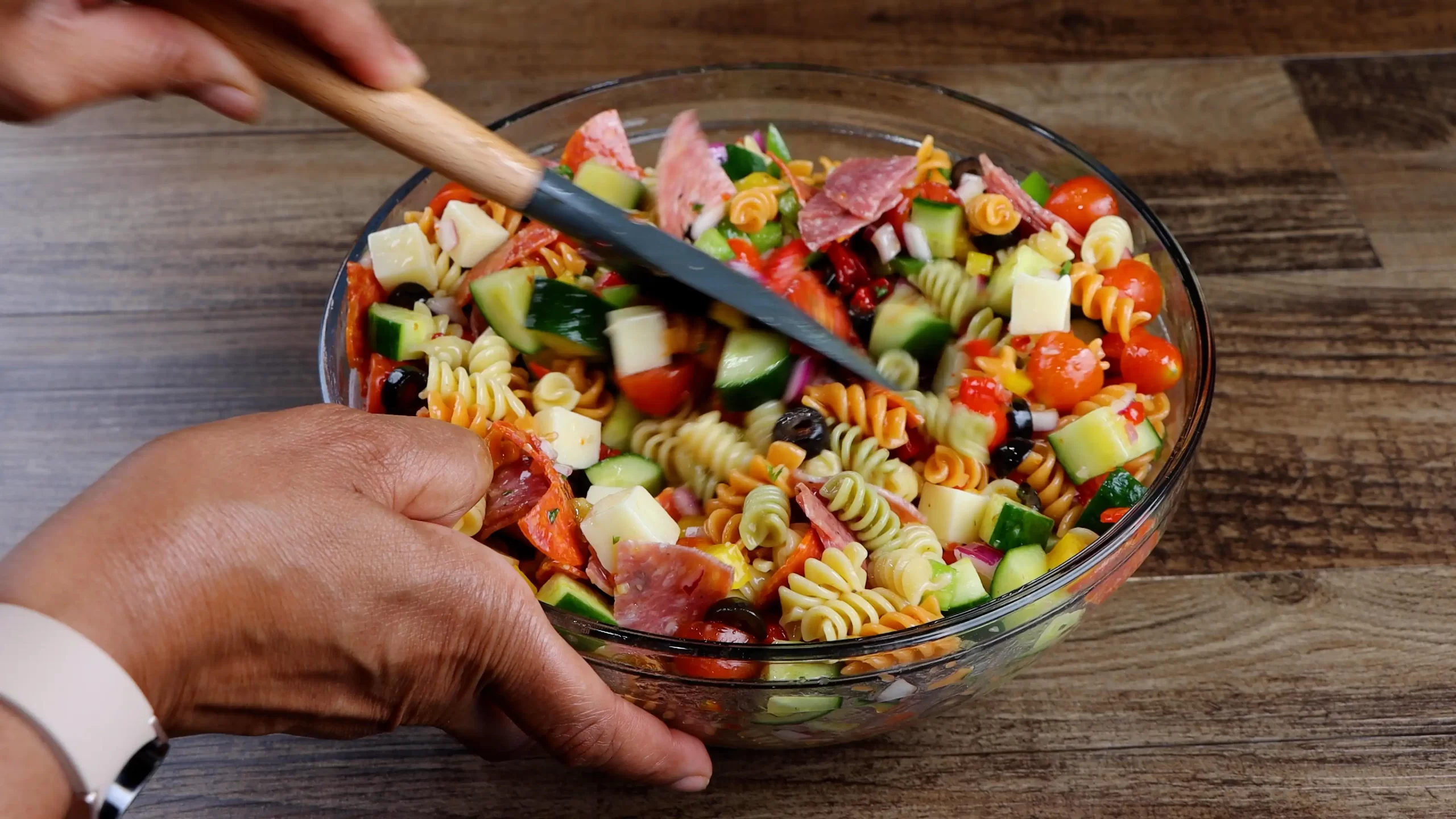 mixing pasta salad