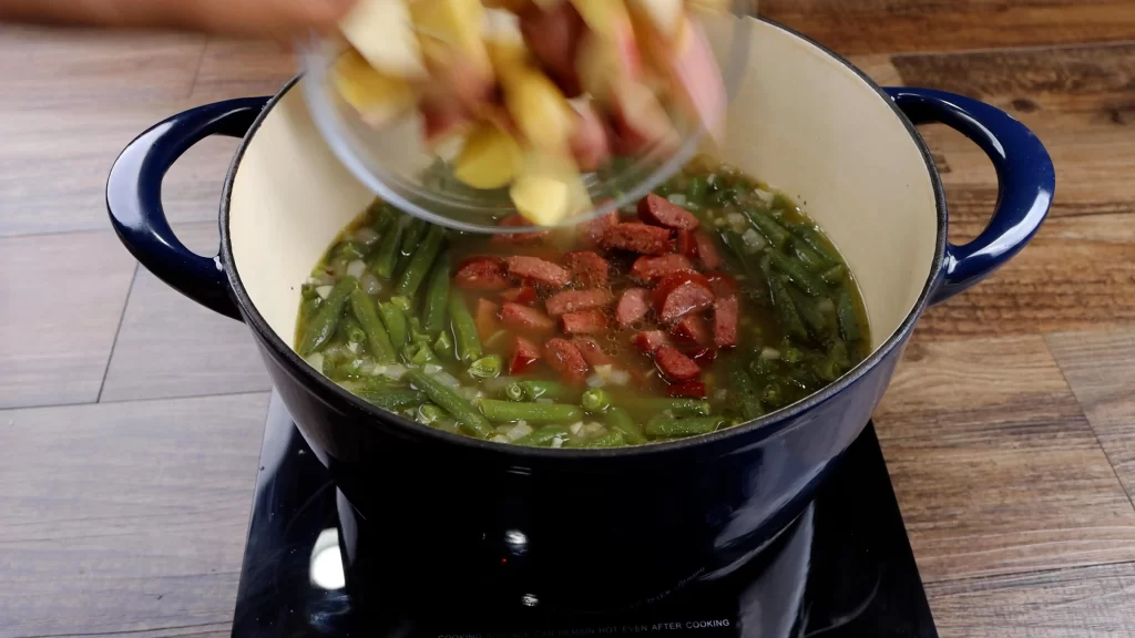 adding the sausage and potatoes