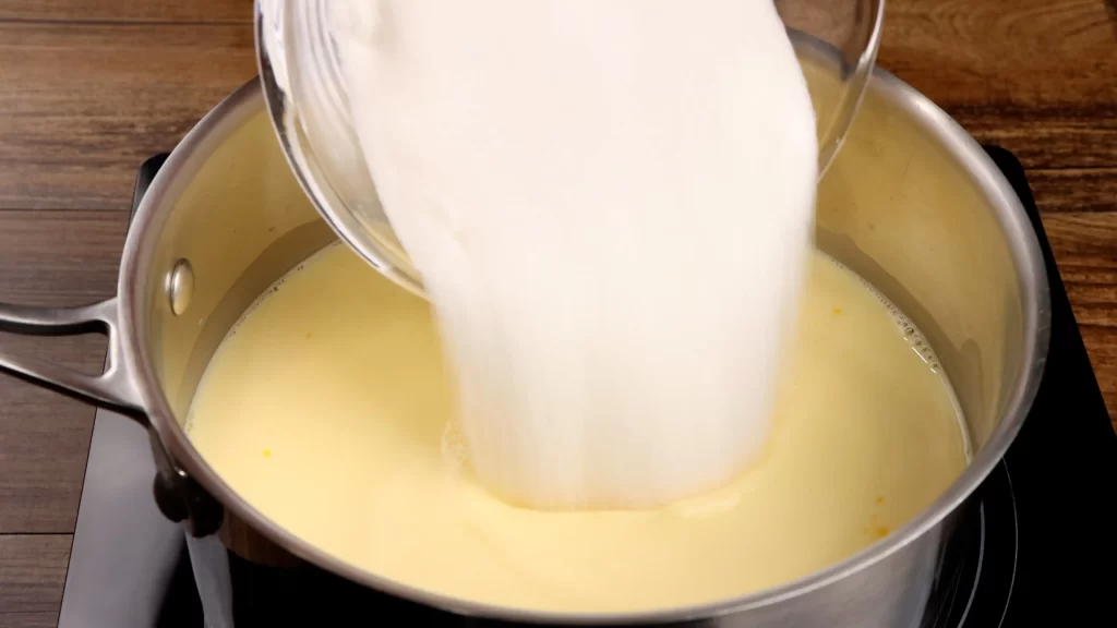 adding the sugar to pudding